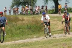 m0723ragbrai - shot 07/22/09 , IA.  Christopher Gannon/The Register --   A unicyclist leads bicyclists down a winding hill north of Lacona Wednesday on RAGBRAI XXXVII.  (Christopher Gannon/The Des Moines Register)