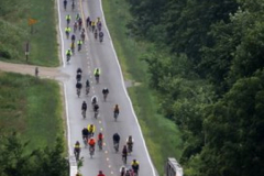 072209ragbraistcharles - Rodney White/The Des Moines Register - Tuesday  July 21, 2009 - Riders take a long down hill outside of St. Charles Tuesday afternoon. RAGBRAI travels from Greenfield to Indianola Tuesday.